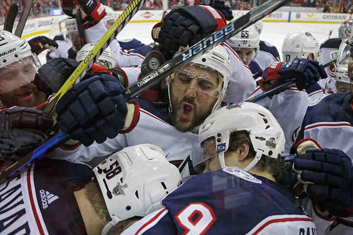 Columbus Blue Jackets' Nick Foligno (71) celebrates with Artemi Panarin (9) after Panaarin scored the game winning goal in overtime against Washington Capitals in Game 1 of the Stanley Cup Playoffs first-round series at Capital One Arena in Washington D.C.  (Kyle Robertson / The Columbus Dispatch)